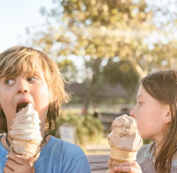Kids enjoying soft serve ice cream cones