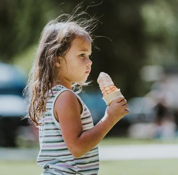 Girl enjoying a soft serve cone