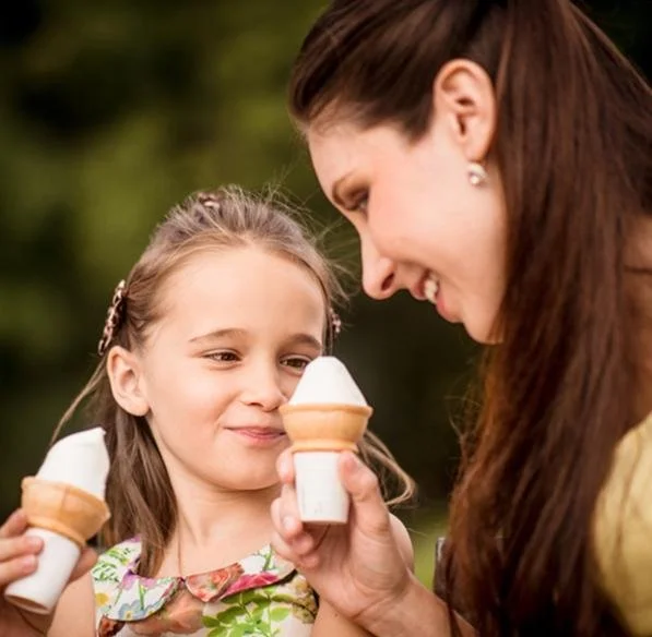 Mom and daughter enjoying soft serve cones