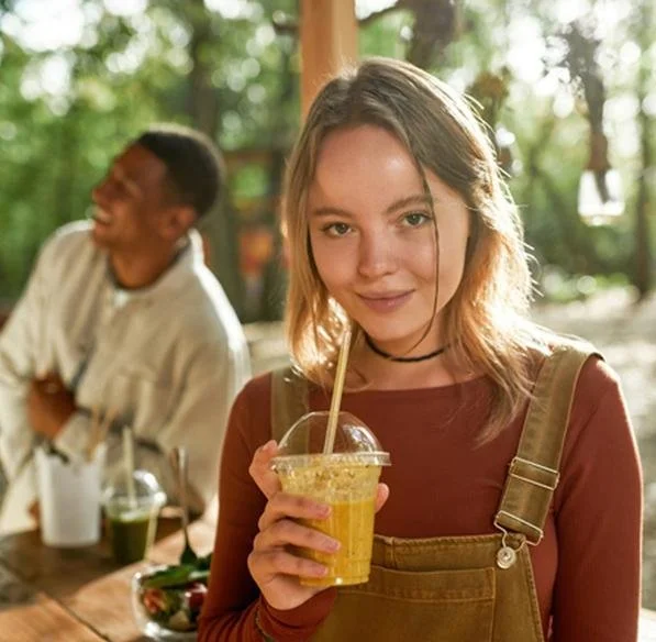 Woman enjoying a mango frozen smoothie