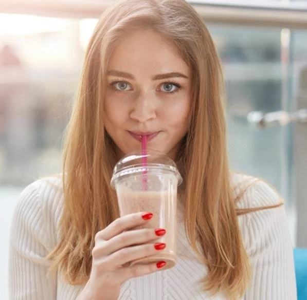 Girl with a coffee frappuccino frozen smoothie