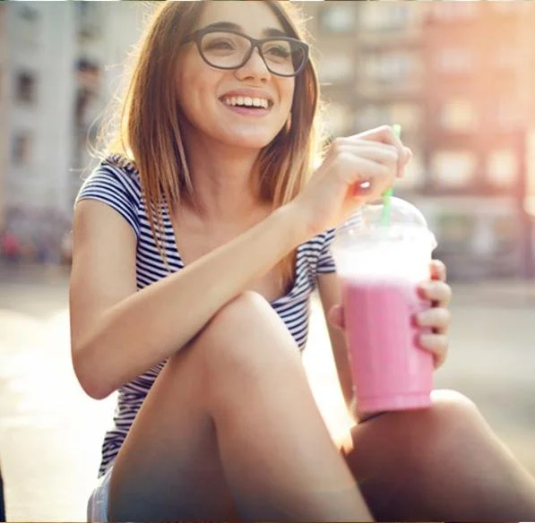Girl with a strawberry frozen smoothie