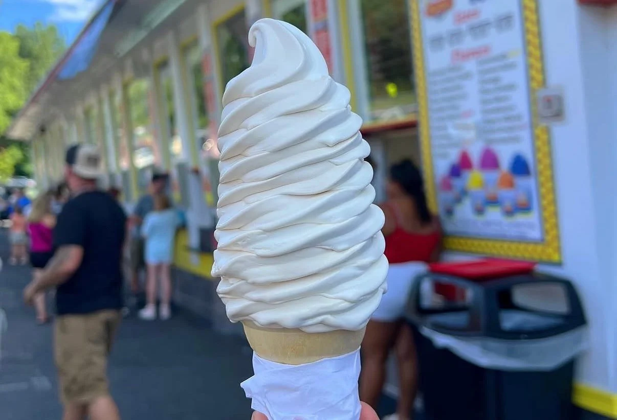 Busy ice cream shop with soft serve machine in use
