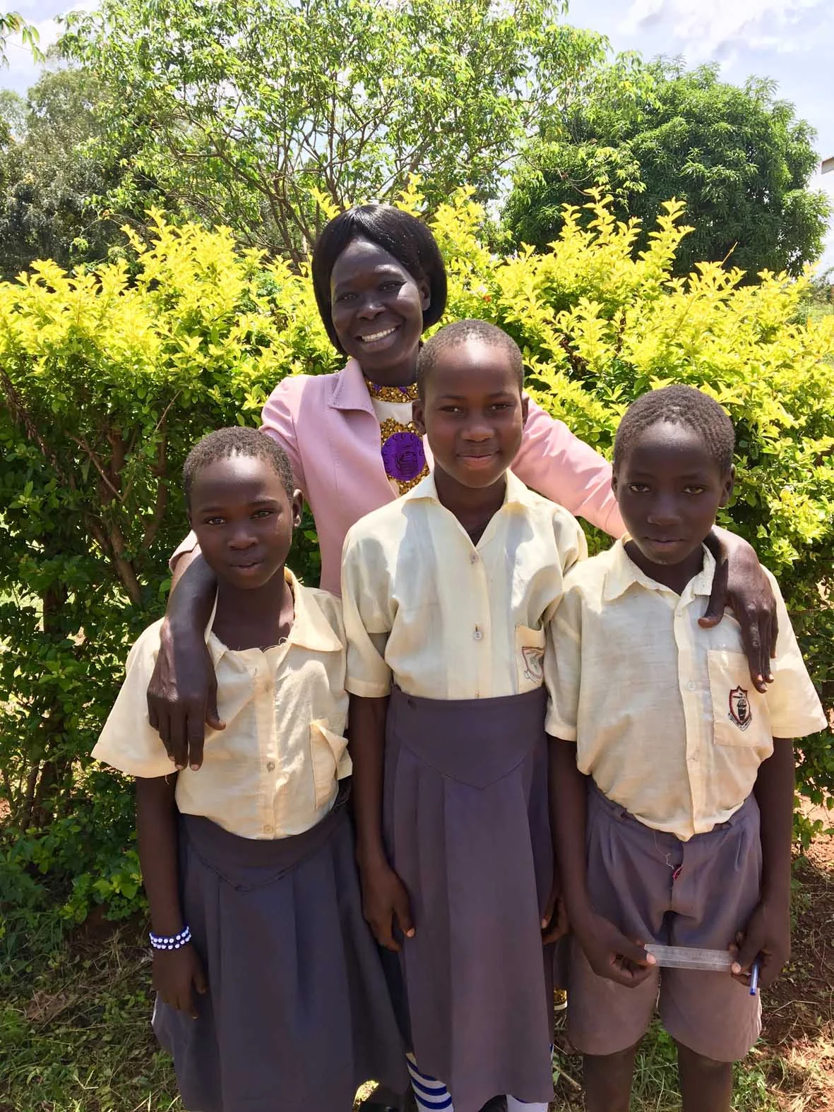 Cubu Primary School P3 teacher with the three best readers in the school after the end of year Early Grade Reading Assessment (EGRA).