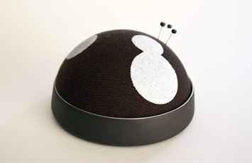 Needle Cushion. (above) Material: Porcelain, Textile. Trivet for a Ceramic Tea pot. (right) Material: Porcelain, Metal and Textile.