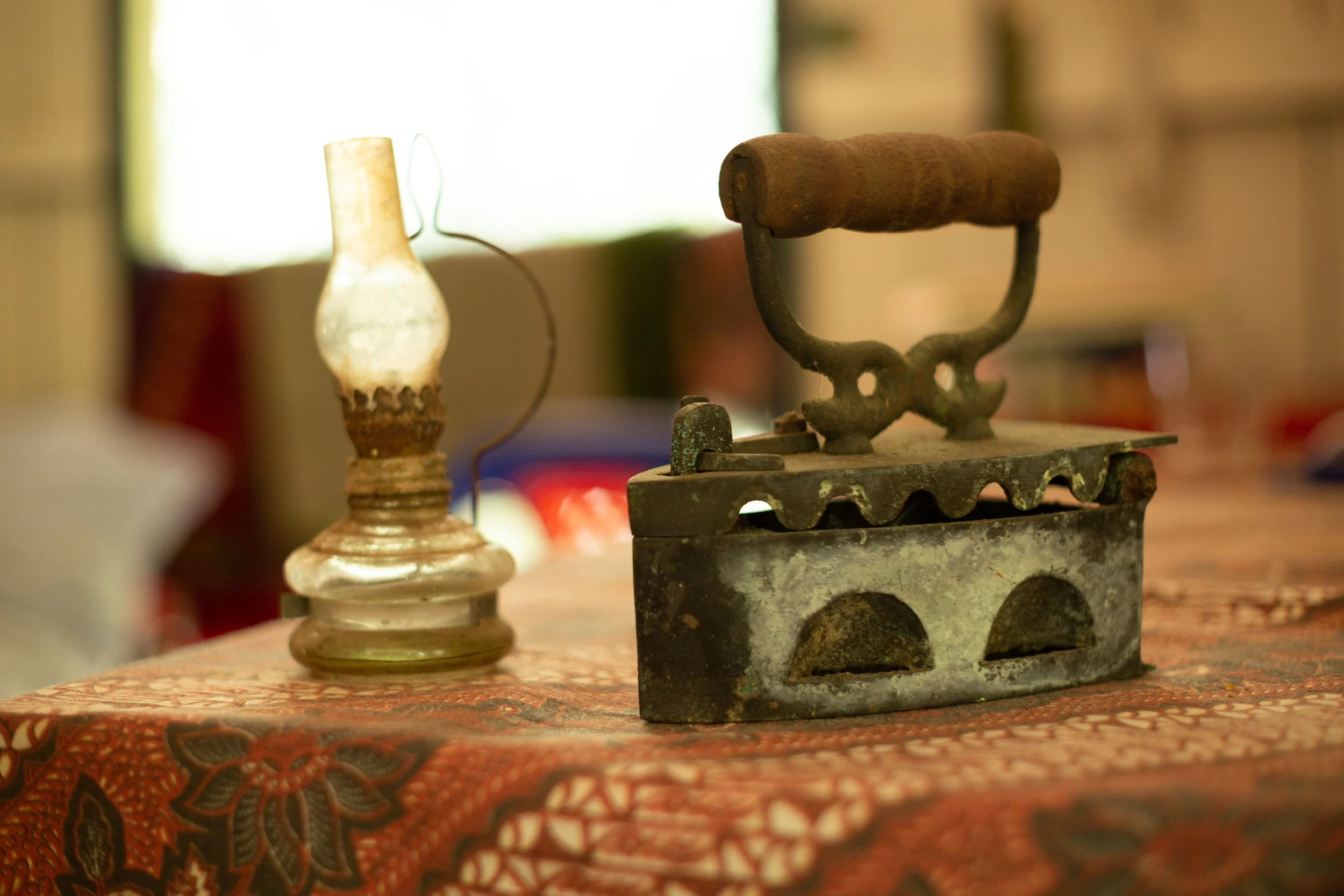 The 19th century kerosene lamp next to a coal-powered ironing device