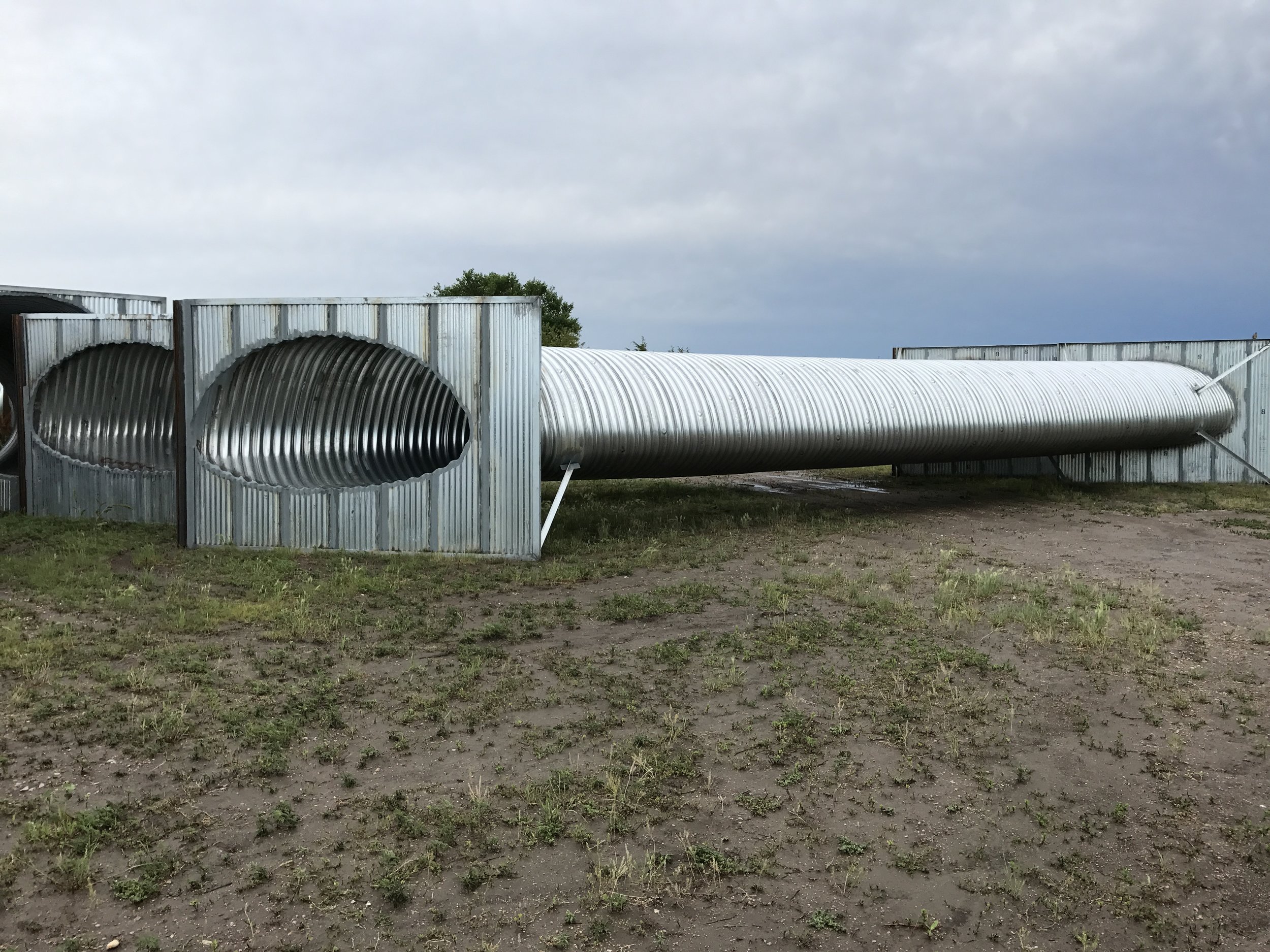 84" Round Equivalent Culvert with Headwalls ready for installation once the timber bridge is removed. Culvert constructed by True North Steel, Huron SD, supplied by Midwest Service and Sales Co, Schuyler NE