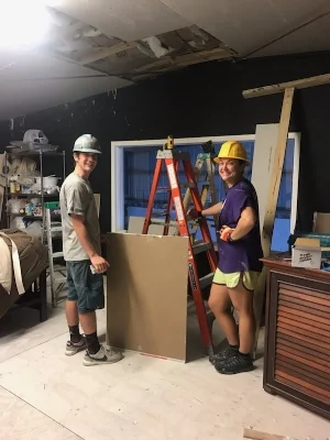 Learning how to hang drywall with our Team Leader Bolf at the youth academy.
