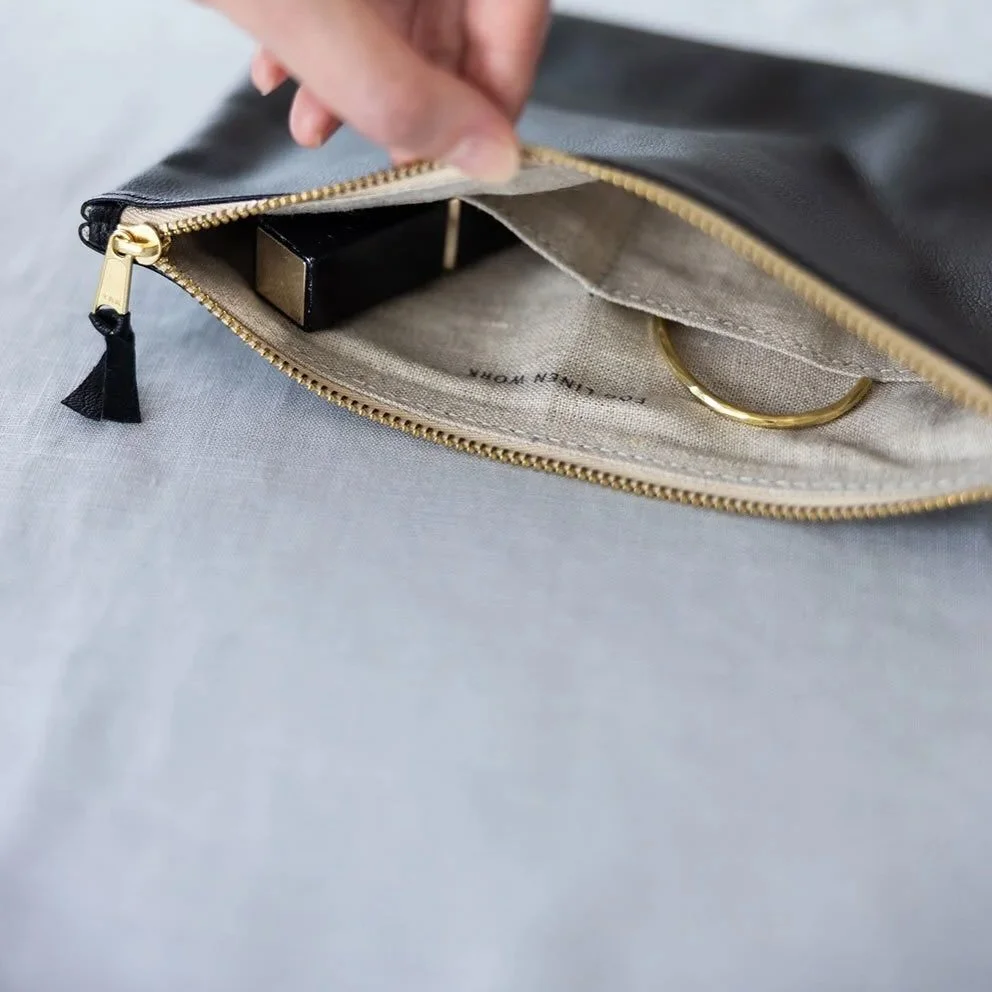 NEW! A flat leather pouch made from genuine cowhide with a natural linen lining and an inner pocket. The medium size is ideal as a cosmetic pouch or for keeping important items safe and organized.