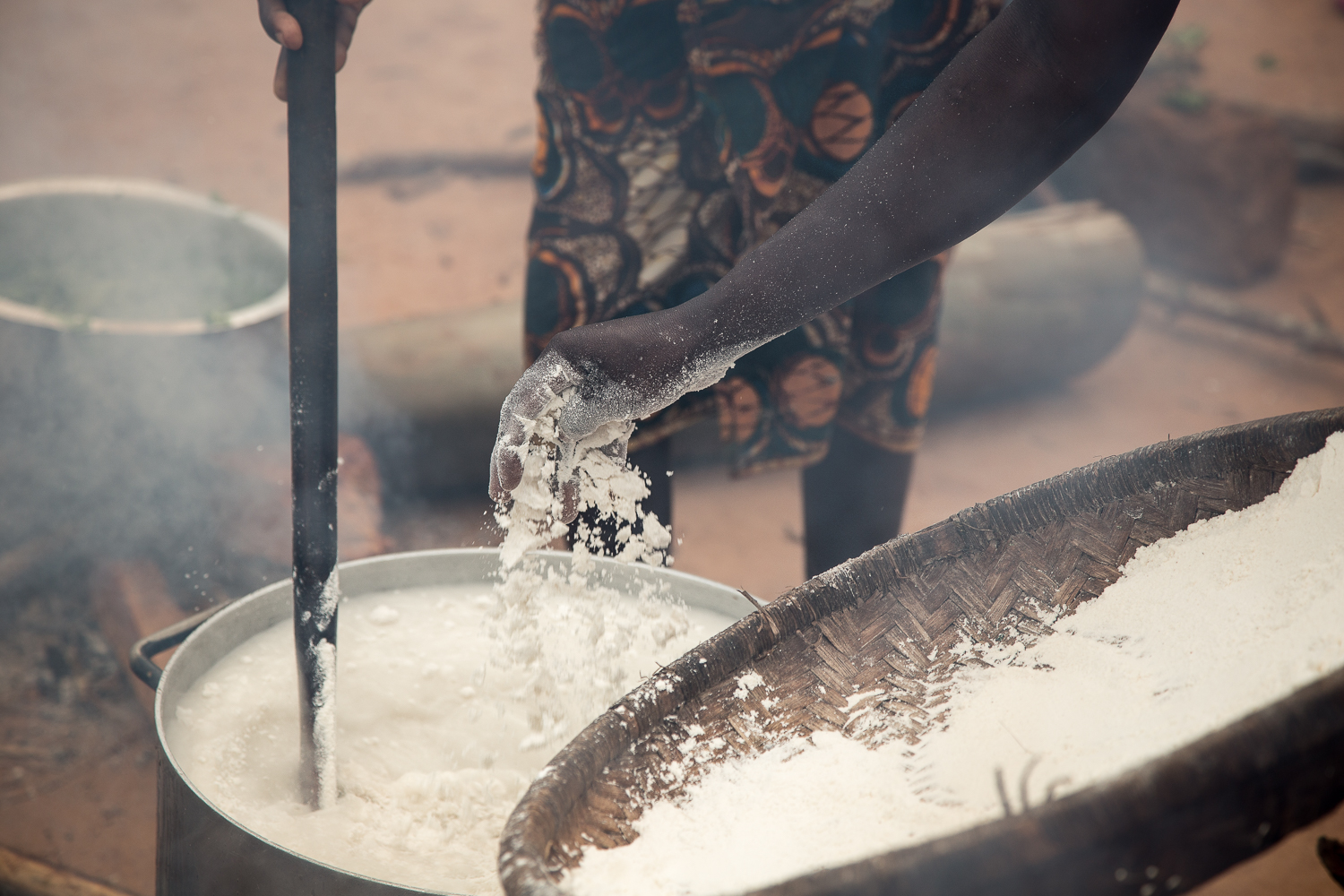  The maize flour is integrated into boiling water, cooked, stirred, cooked, etc... until the Nsima is ready to eat. It is hard work, and the smoke from the fire can be overwhelming, so there is a lot of taking turns. 