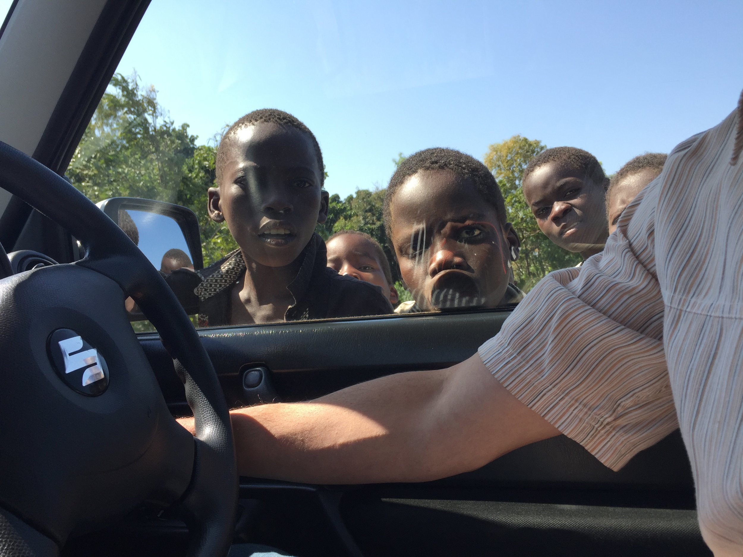  Stopping on rural roads often drew crows of children, checking out the "Mzungu" (this literally translates to "travler" but is the mostly endearing term for "white people"). Stopping on the side of the road, you would usually hear a child yell it, a