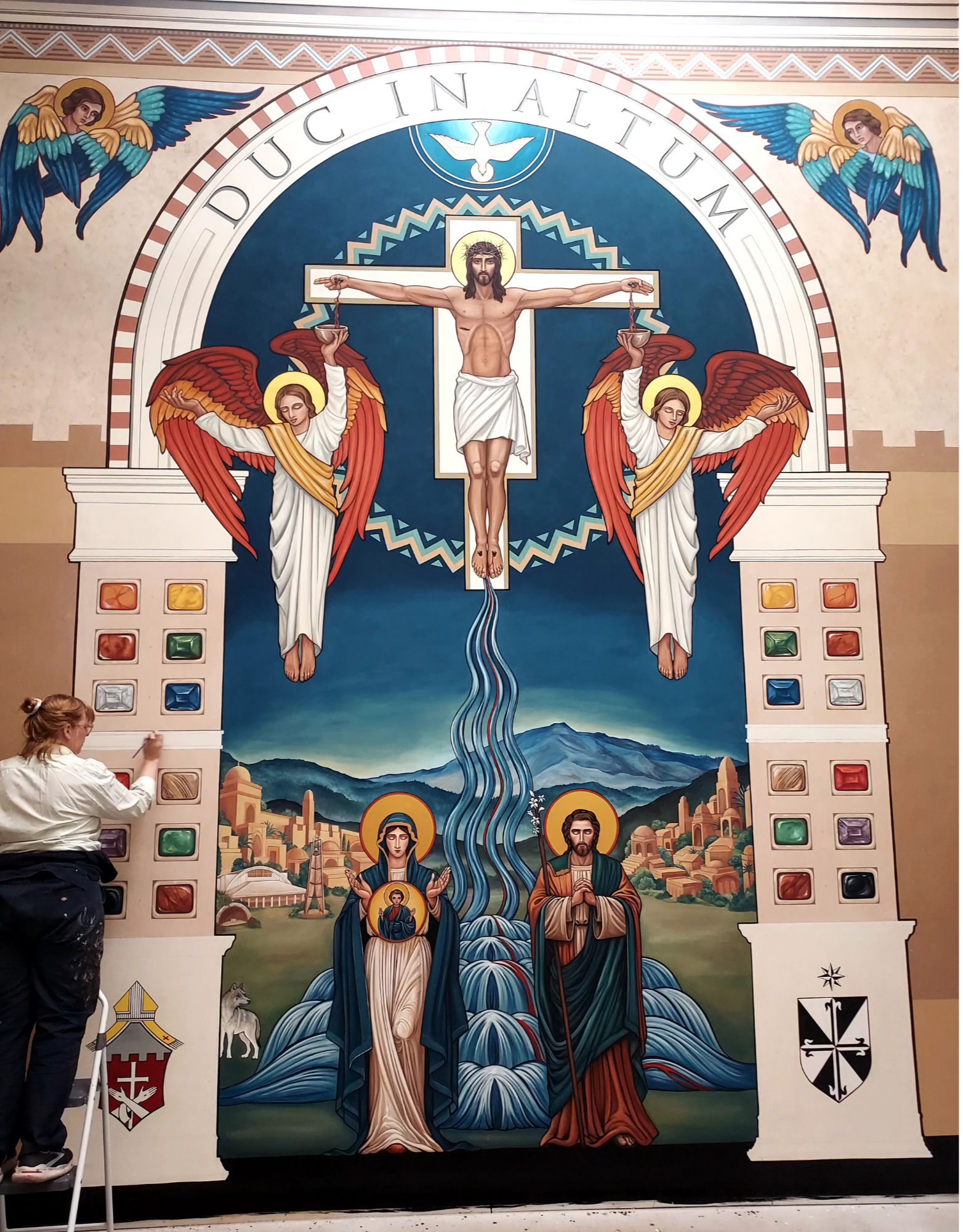 Ruth Stricklin painting the sacred art mural, Duc in Altum