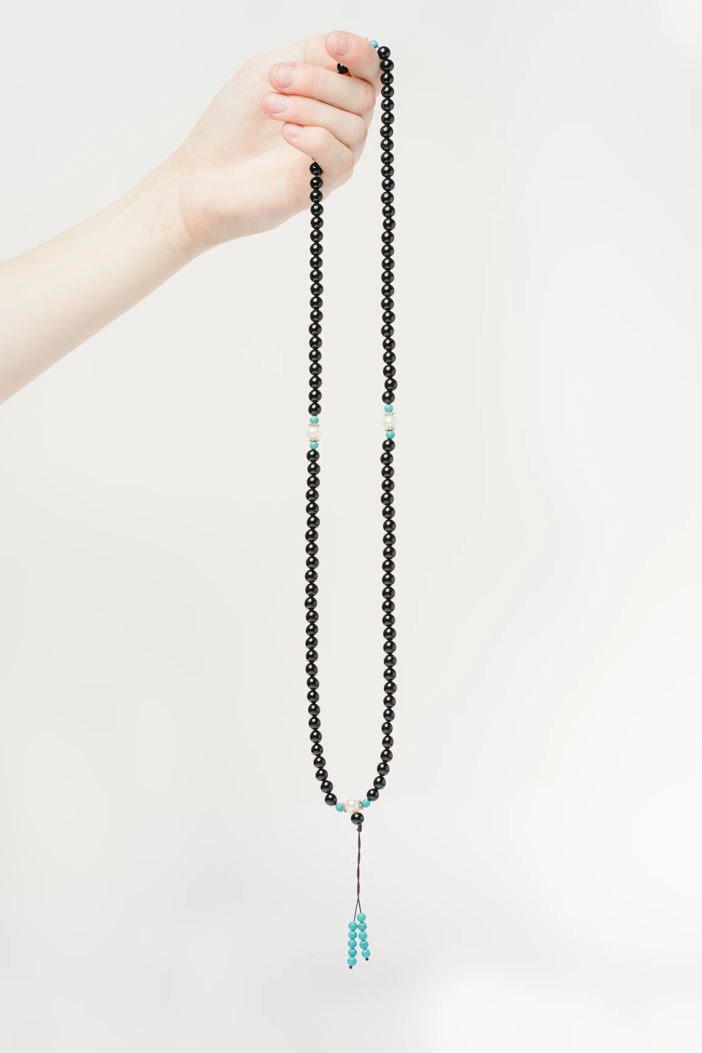 Black and white mala held.jpg