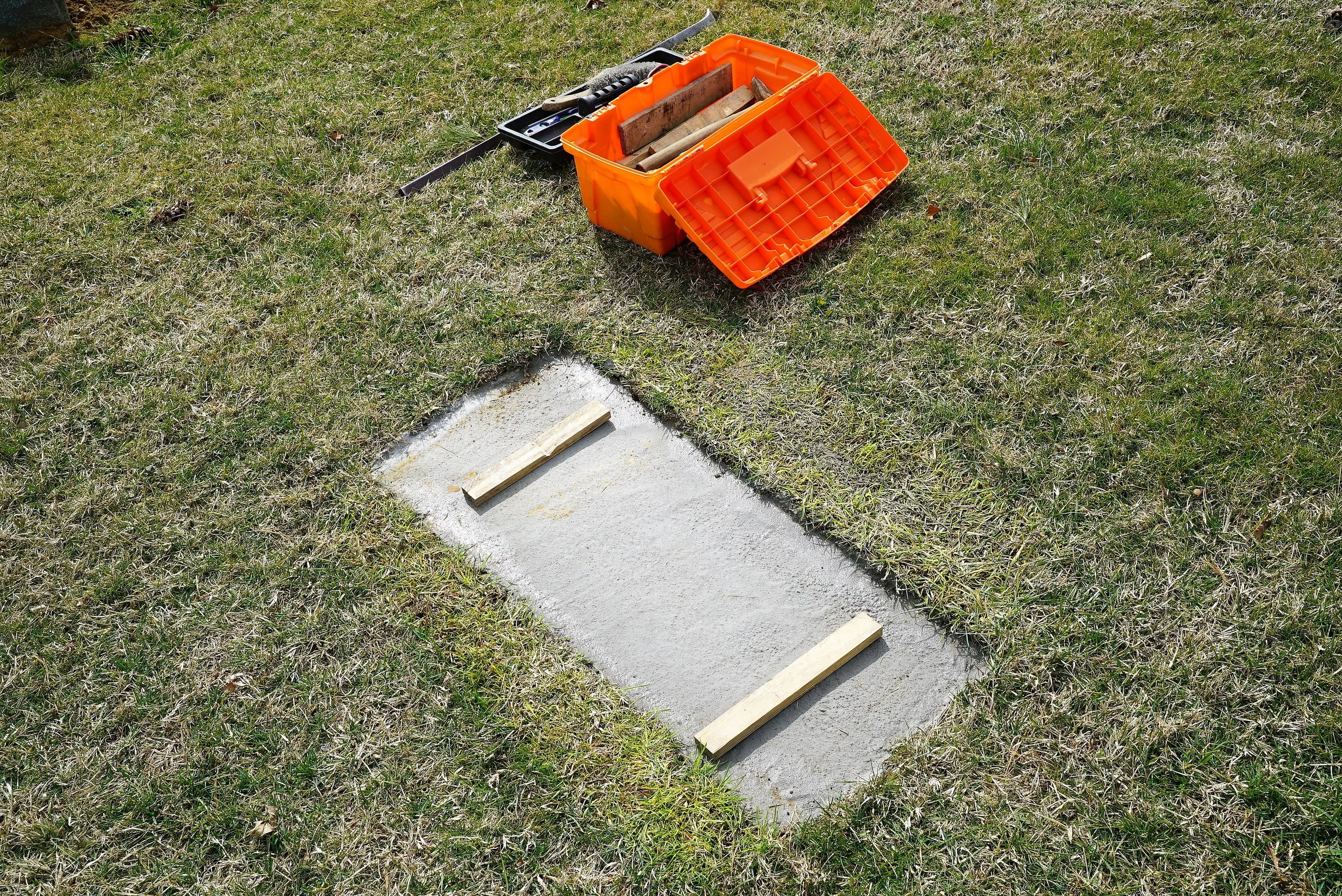 Photo of a foundation at a grave. The headstone rests on top of this. (The wood is temporary. It is part of a stone-setter's "tricks-of-the trade.")