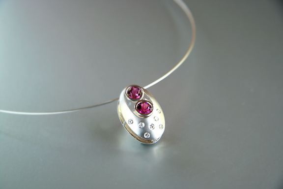   14k white gold domed sandwich pendant with 2 pink tourmaline and burnished diamonds  