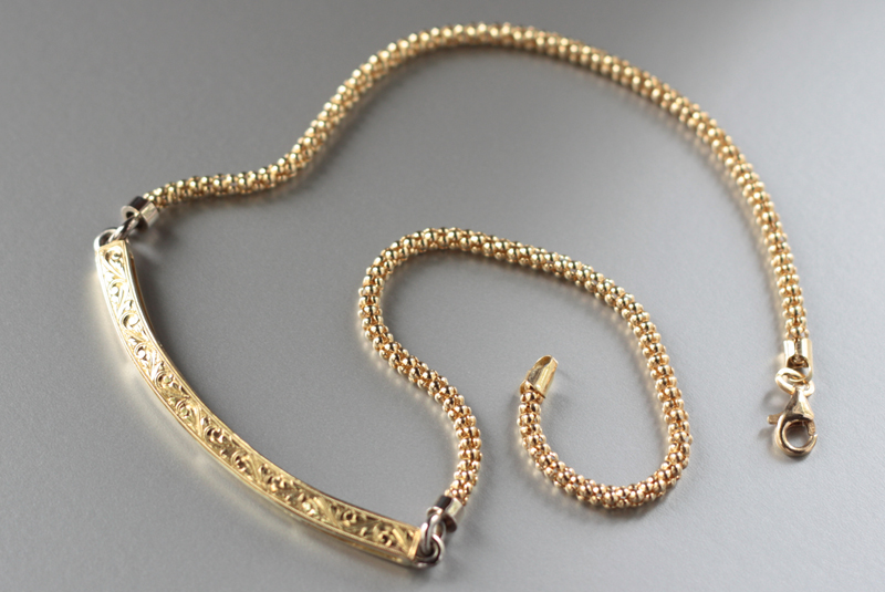   18k handmade, hand-engraved neckpiece. Designed to be customized with dangling charms.  