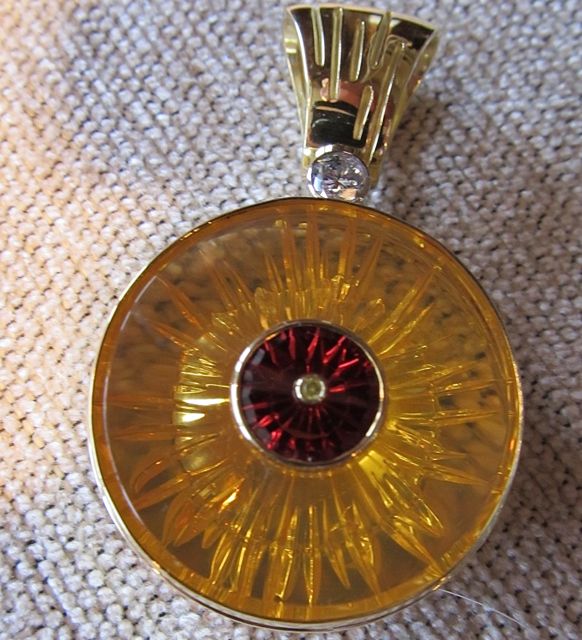   18k yellow gold, 3" diameter fire opal pendant with garnet and diamonds.  