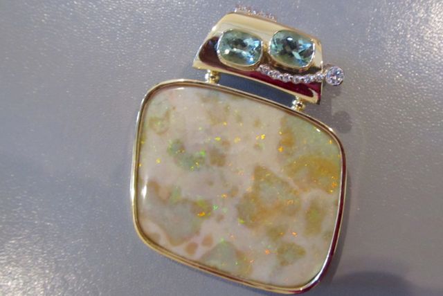   Two-sided pendant. Side B: 18k gold, bezel set Andamooka opal that has been polished front and back. Set with 2 green tourmaline and 2 diamonds.  