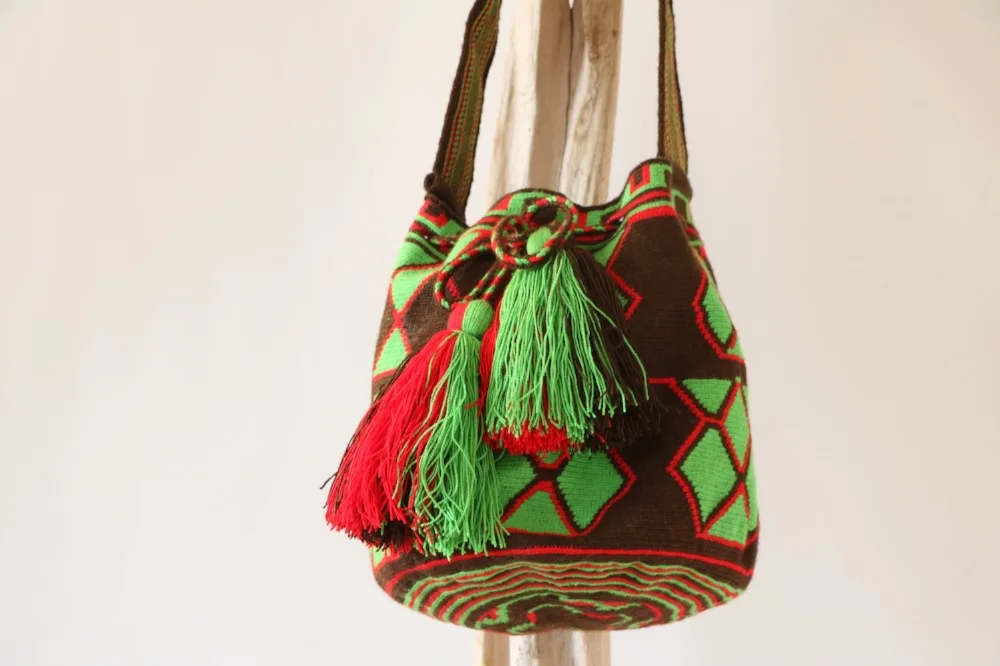 wayuu mochila green brown and red mochila made in colombia sold in usa with green tassles hand loomed hand woven mochila bag talin's bazaar spring finn and co