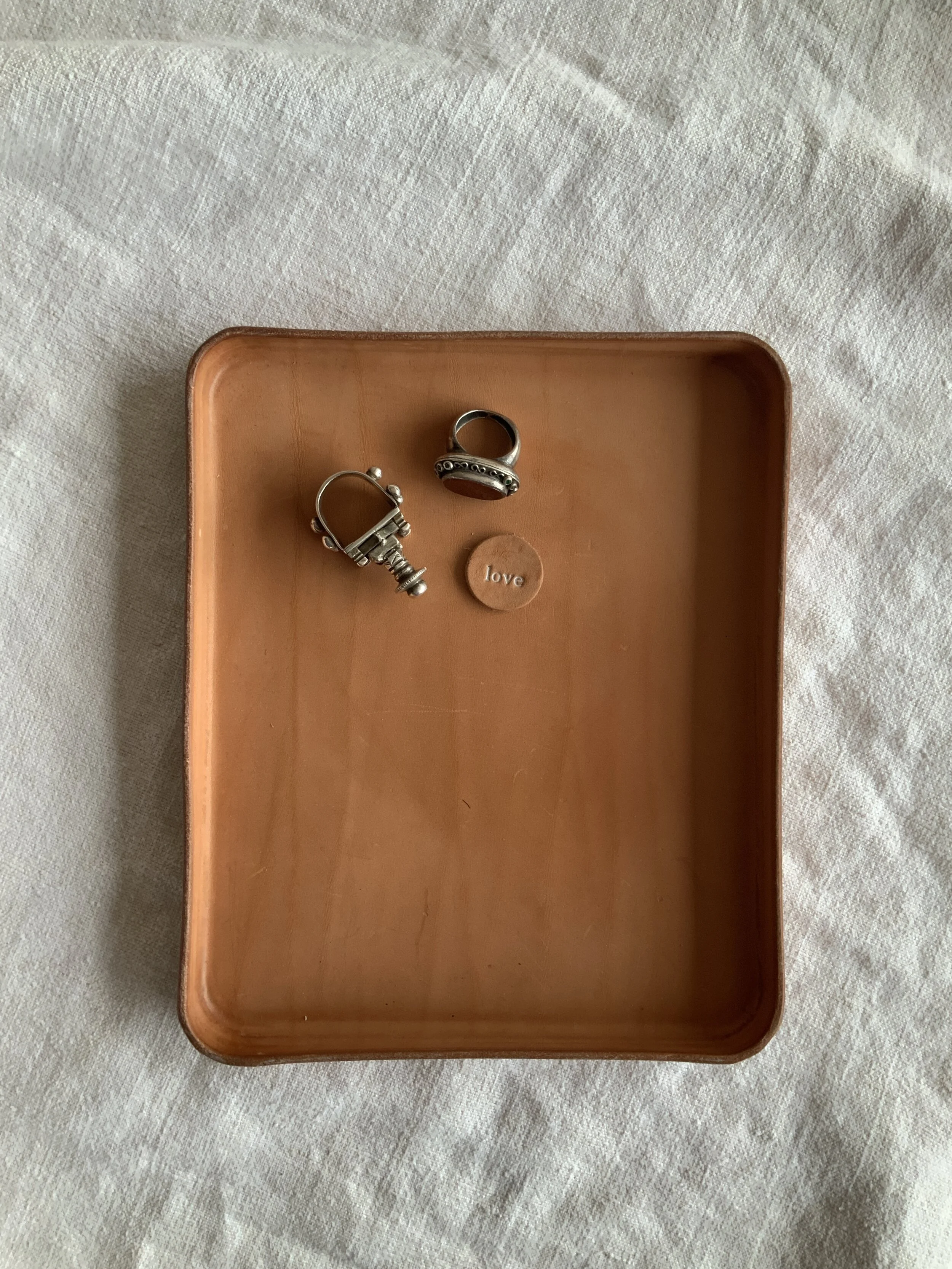 vegetable tanned leather tray holding jewelry
