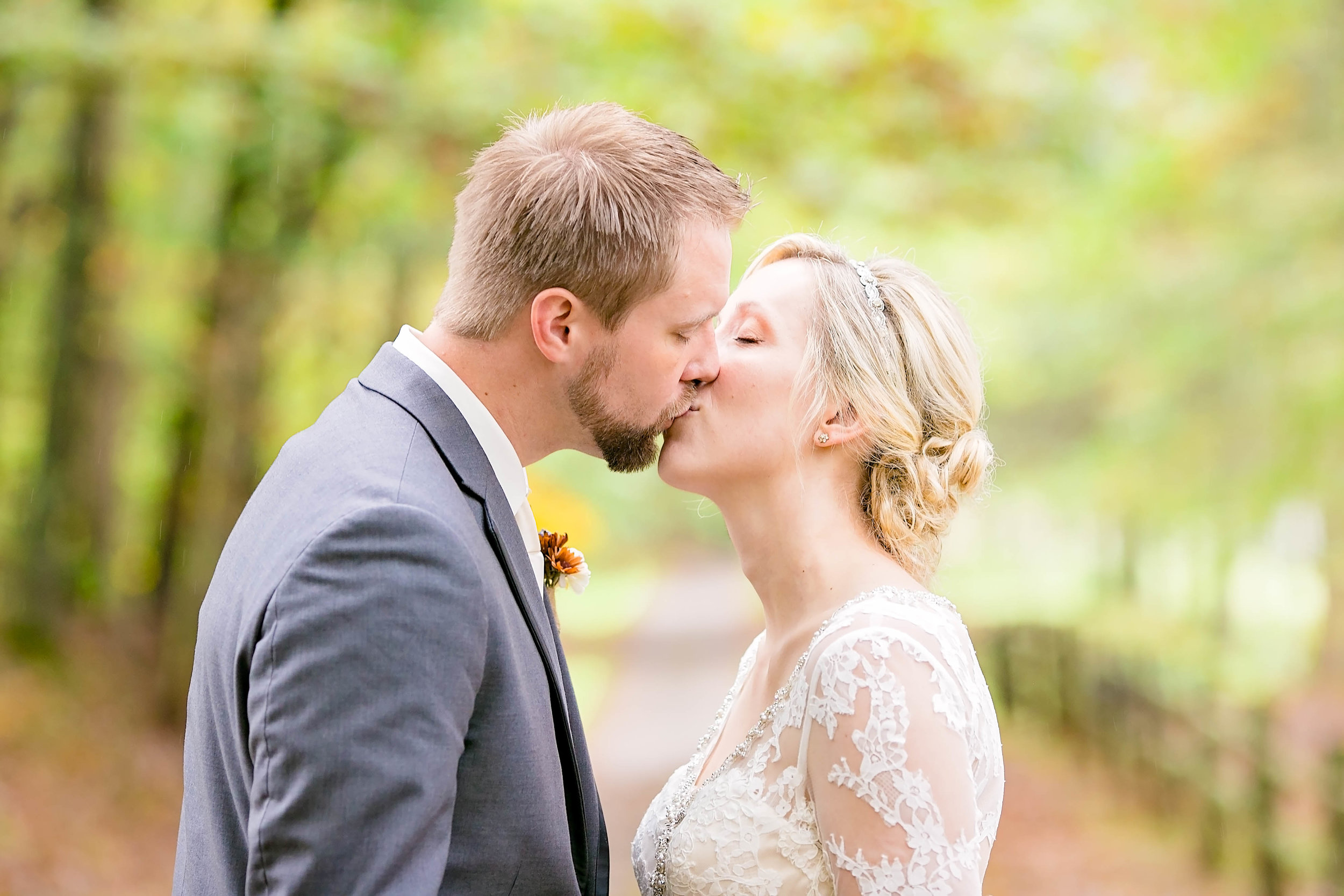 Bride and groom kiss, fall wedding