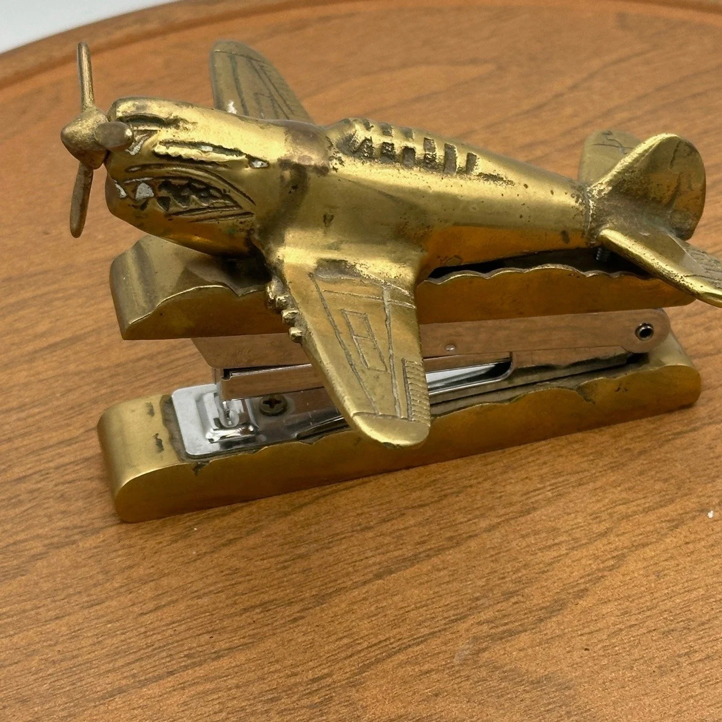 **Vintage 1960s/70s Brass P-51D Mustang WWII Fighter Plane Stapler** 
This vintage piece is made of solid brass and is in working condition. Known as the Flying Tigers during WWII, this airplane's propeller turns, and the stapler functions properly. 