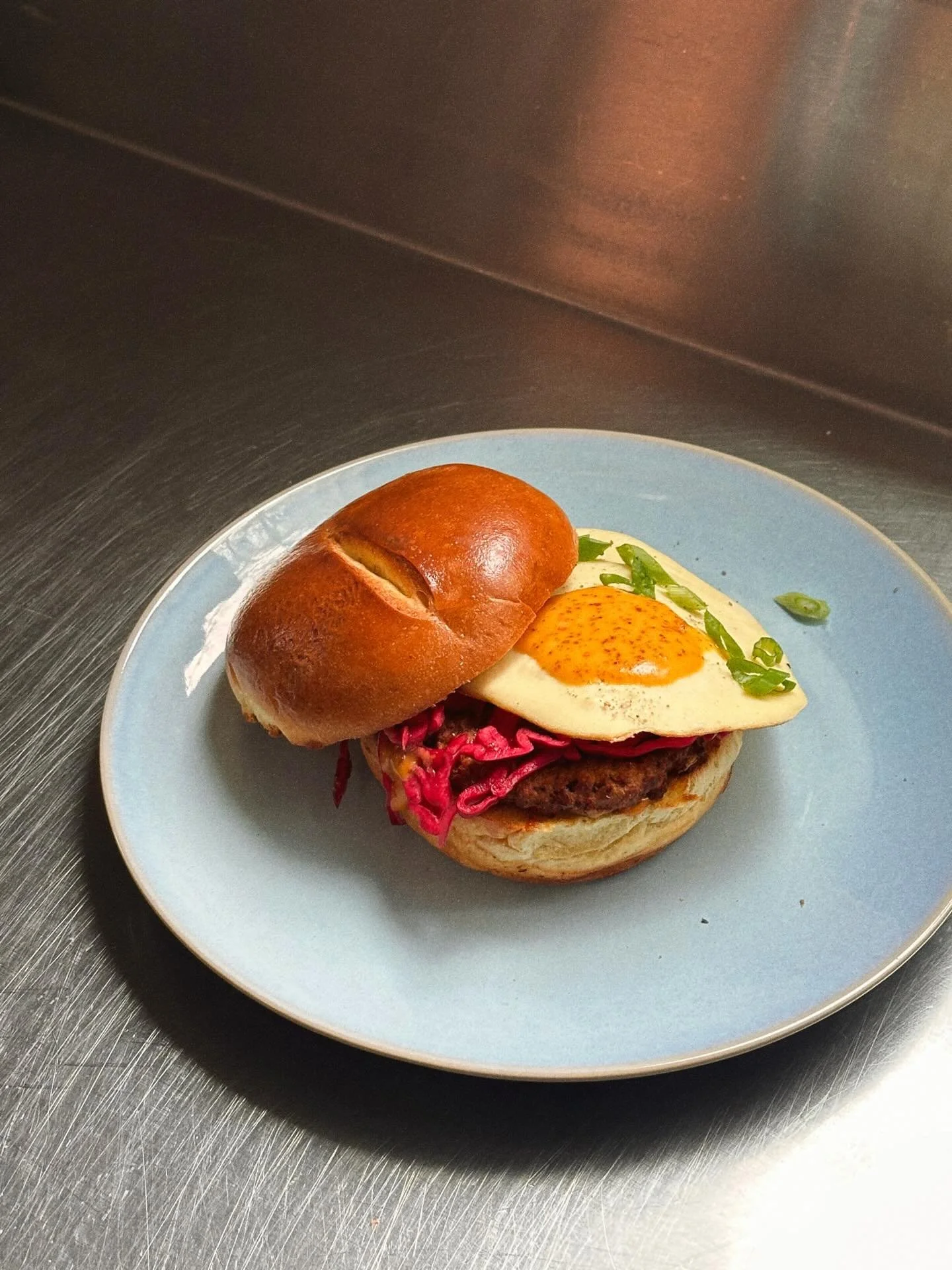 THE ZIP &bull; Did you get to try this breakfast sandwich feature? Sausage patty, pickled cabbage, chili crunch mayo, green onion and a fried egg  on a toasted brioche bun🍳