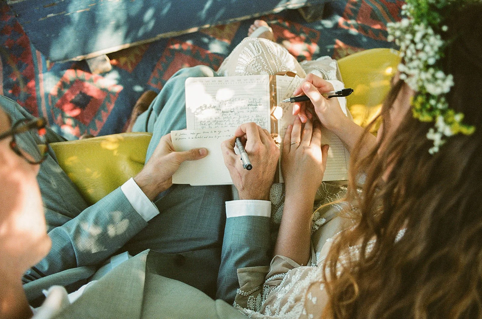 Couple writing in notebooks, close-up