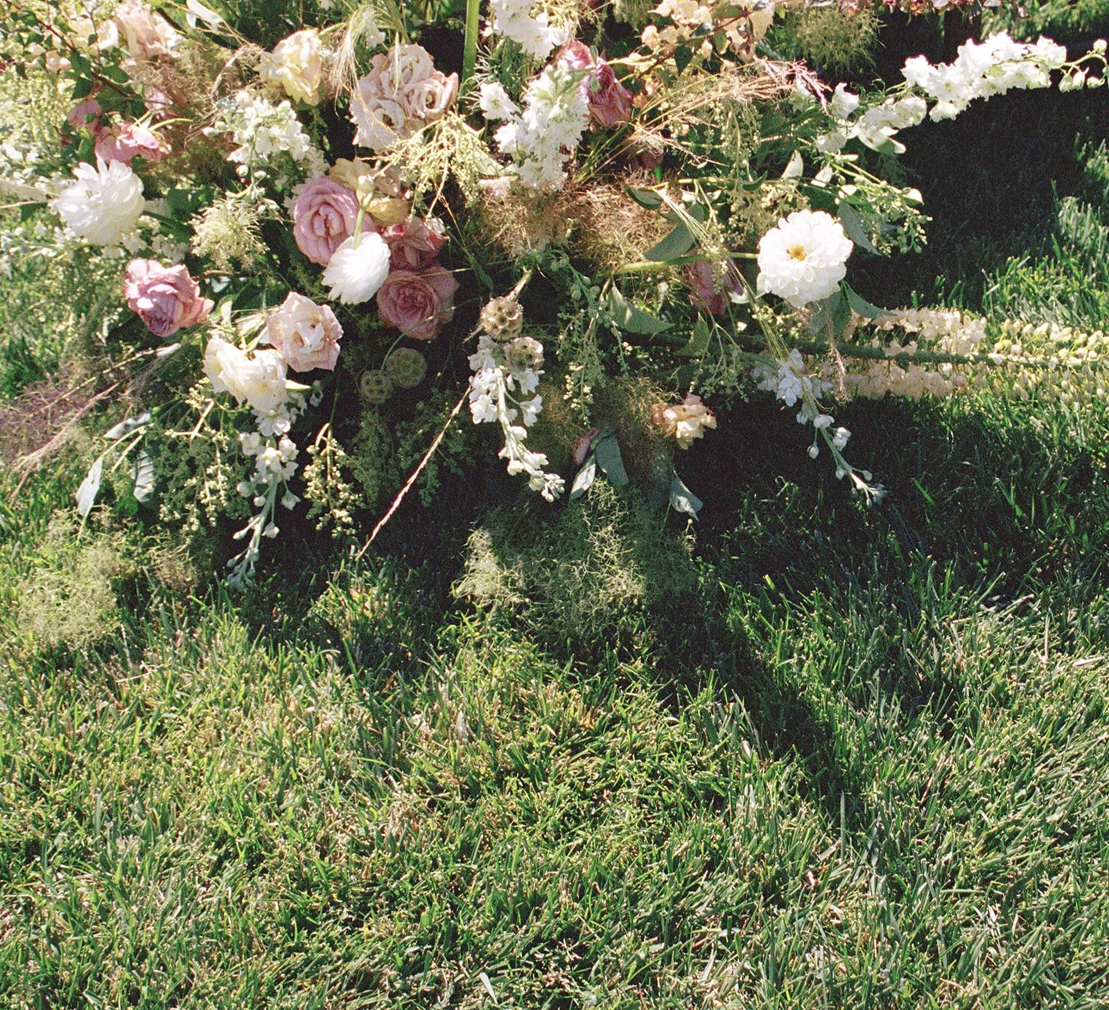 Bouquet of pink and white flowers on green grass