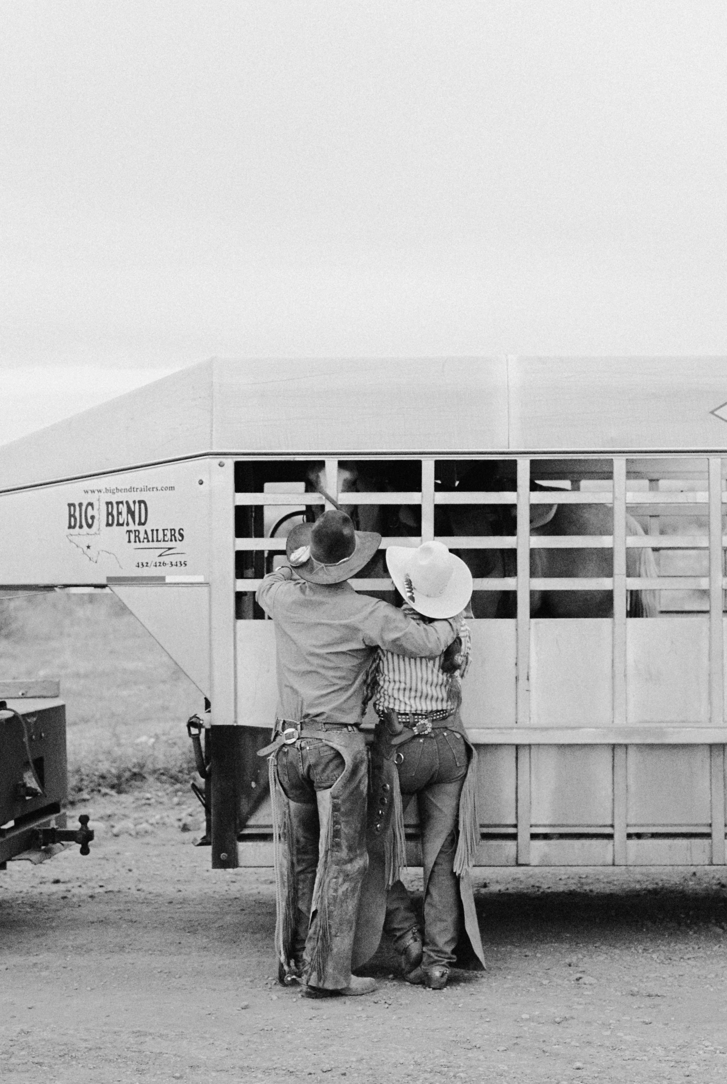 a film photo of a couple with their horse trailer