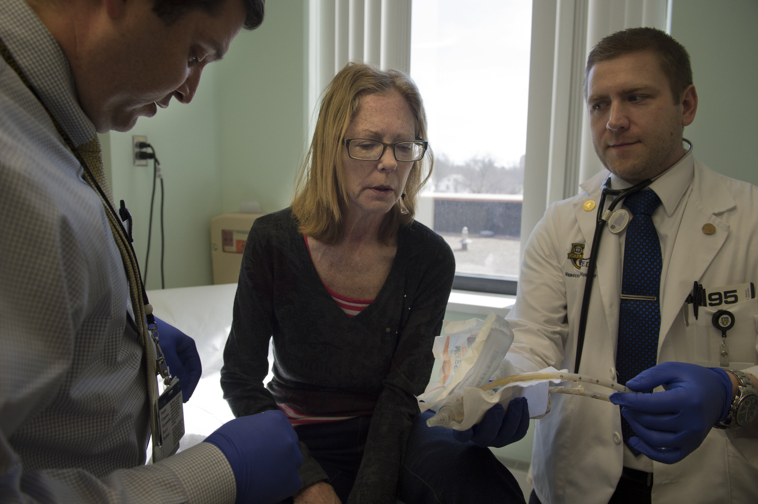  Carol is shown the chest tube that was inserted for lung drainage after a biopsy by her surgeon after it is removed. 