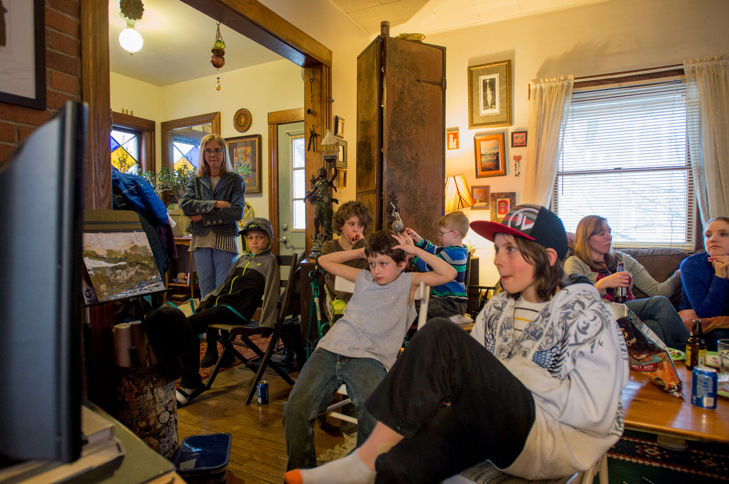  Carol Heveron (far left) watches over her relatives and grandchildren as they watch TV at her house on Easter Sunday. 