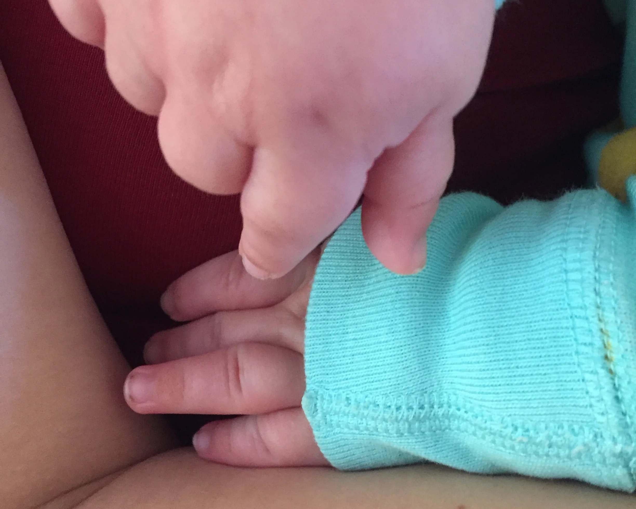 The tiny fingers of Baby Amari Harkin.