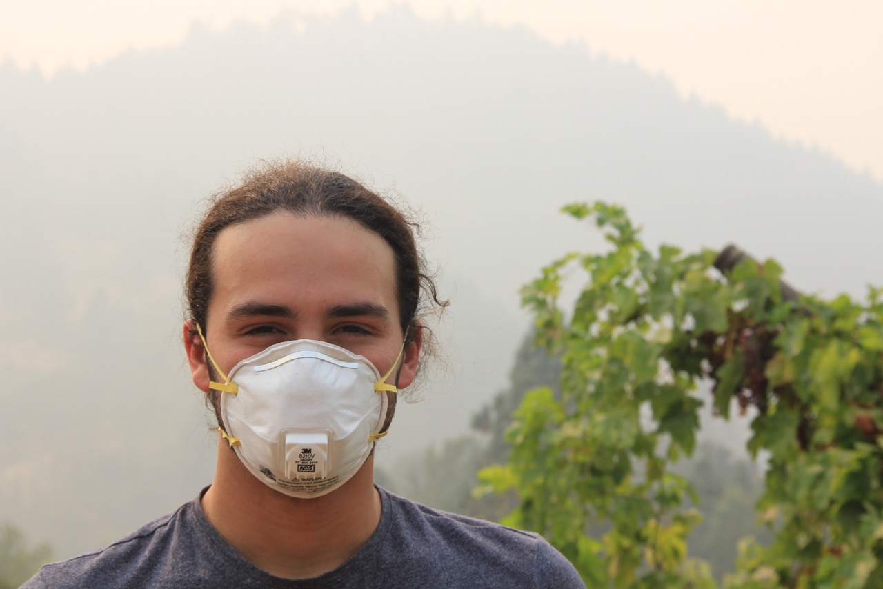 Jacob wearing a mask while working on his family's farm in Oregon this summer, when the smoke from nearby wildfires made it unsafe to breathe normally outside.