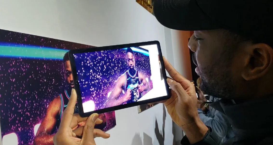 Dwyane Wade looking at the AR experience we created for his event.
