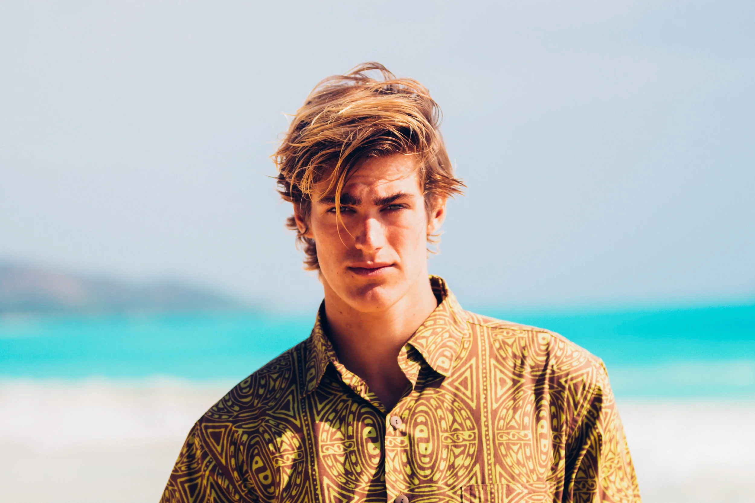 This is our Aloha style shirt. Made of 100% cotton with a standard collar, coconut buttons and one pocket. Cut long, with side slit seams for comfort and flattering fit. Our shirts are cut big so we highly recommend you order one size smaller than what you would normally wear. For example, if you are a Small you will definitely want to order XS. $86.00