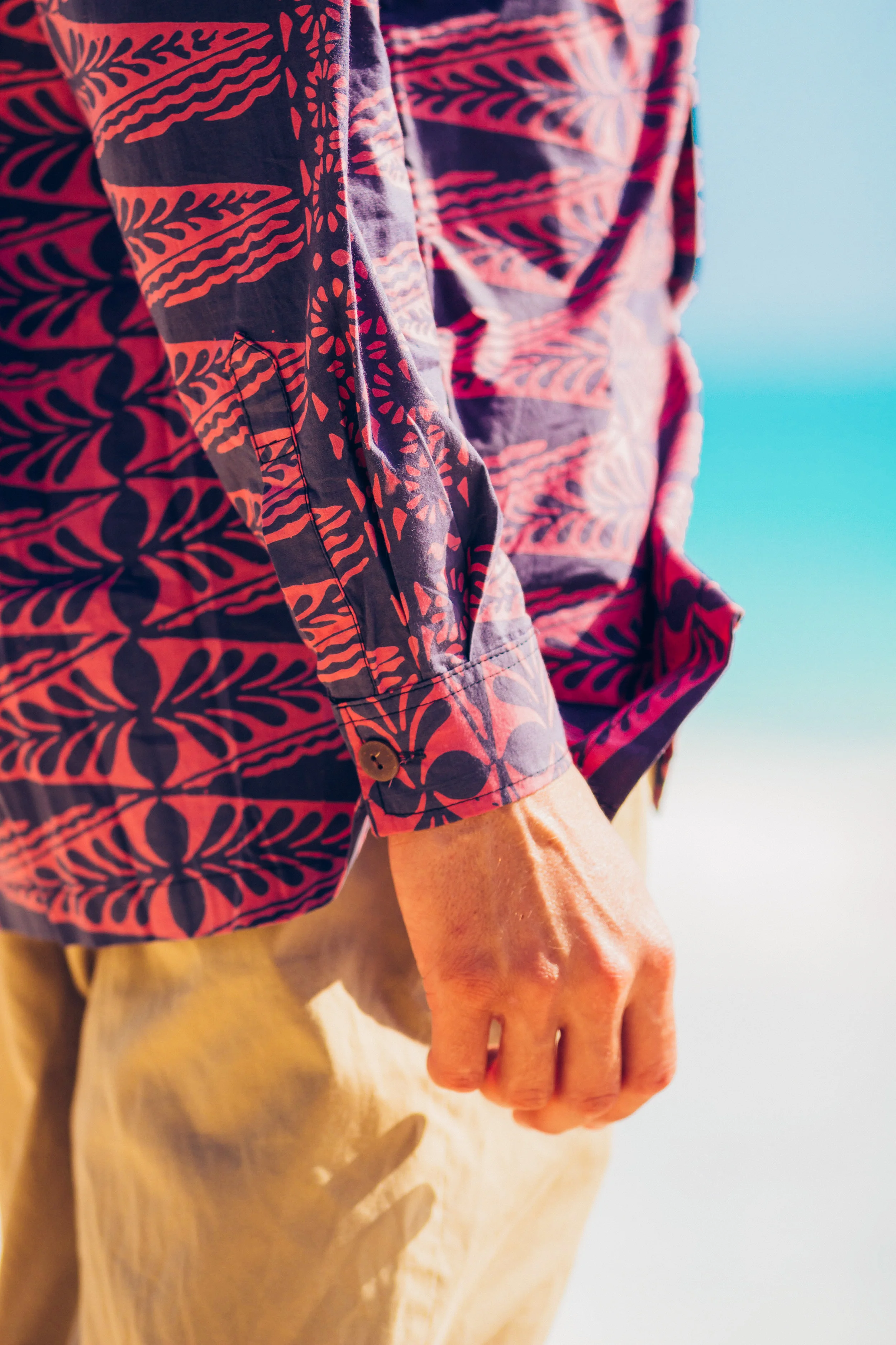 This is our Aloha style shirt. Made of 100% Cotton with a standard collar, coconut buttons and one pocket. Cut long, with side slit seams for comfort and flattering fit. Our shirts are cut big so we highly recommend you order one size smaller than what you would normally wear! For example, if you are a Small you will definitely want to order XS from us! $110.00
