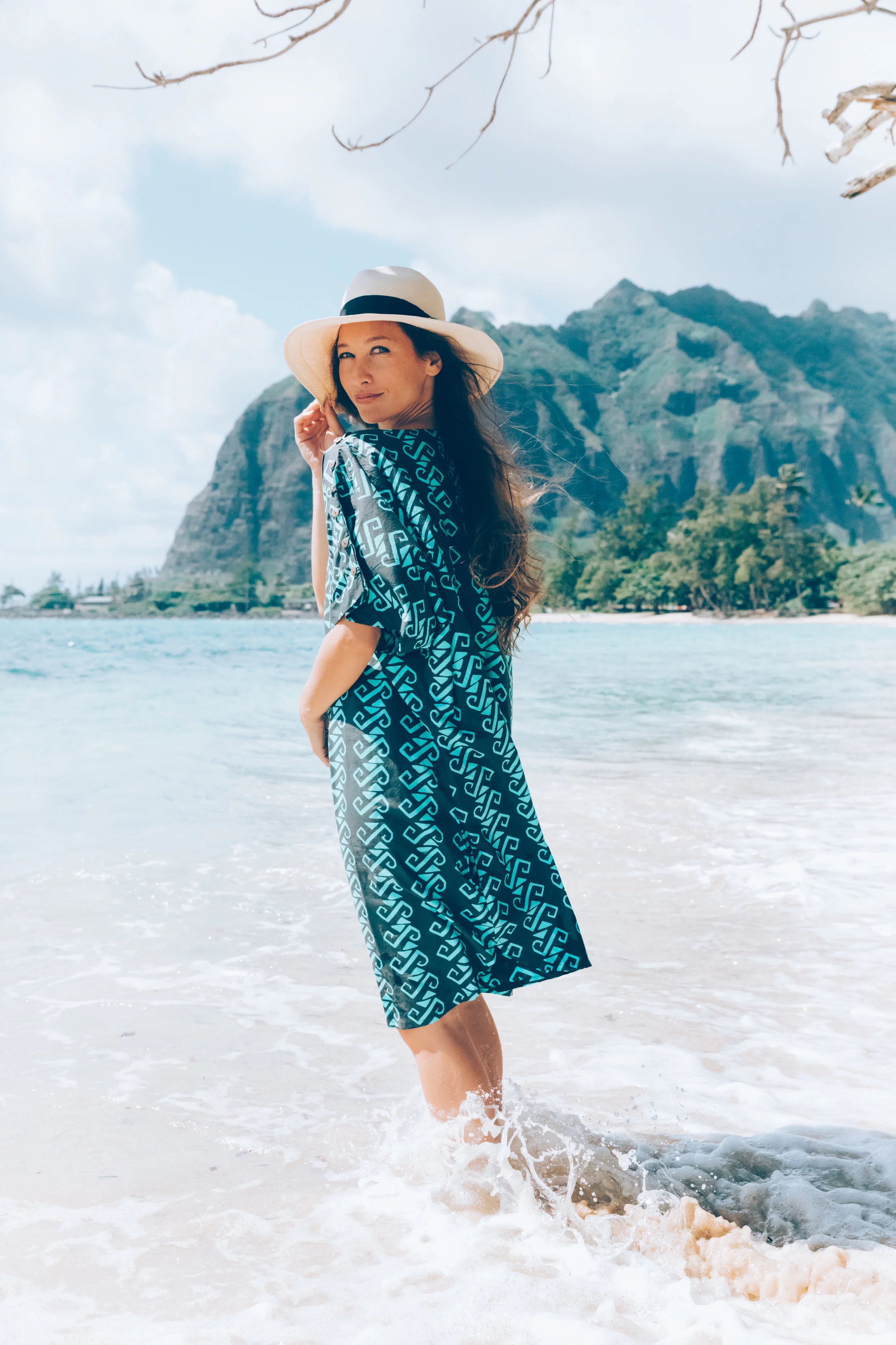 The Tanapeg is 100% cotton and one-size fits all. This cover-up features two slit pockets and coconut buttons down the sleeves. $98.00.