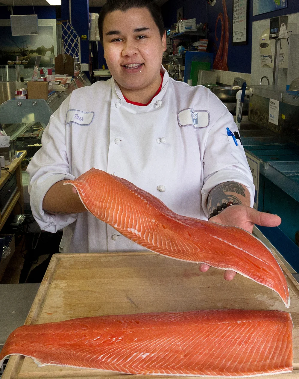 Fresh Ideas Start Here holding a fresh Wild BC Chum Salmon