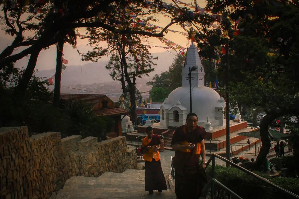 Monks with mobiles | Swayambunath Stupa | Kathmandu. Often referred to as monkey temple for the swelling population of Bandar monkey's, the beauty of Swayambunath is in it's incredible mix of Buddhist and Hindu architecture and harmony. A monastery houses monks who live amongst the trees and the monkeys whilst Sadhu's offer tourists photo opportunities... but at a price.