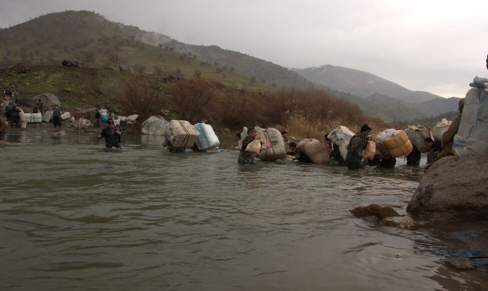 Kolbers cross a stream. Source: Kurdistan Human Rights Network