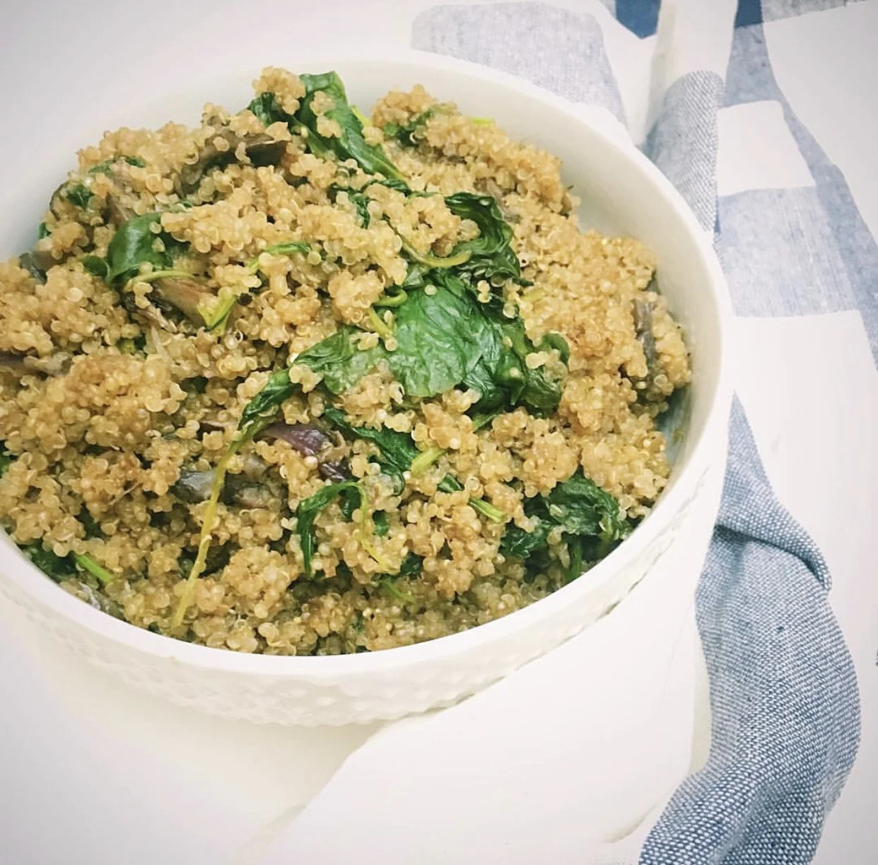Ingredients: 1 tbsp olive oil 1/4 cup sliced onions 1 cup sliced mushrooms 1 cup rinsed quinoa 2 cups low sodium chicken broth 2 handfuls spinach Salt and pepper to taste Steps: 1. Heat up olive oil in pan 2. Add onions and mushrooms and cook till onions and translucent and mushrooms have sweated quite a bit, 4-5mins 3. Add quinoa and stir fry 30seconds 4. Add broth and bring liquid to a boil. Once boiling, turn heat to low and simmer 20-25mins till quinoa is fully cooked 5. Add spinach and cover pan so that spinach steams and wilts. 6. Stir to mix in spinach, serve hot and enjoy!