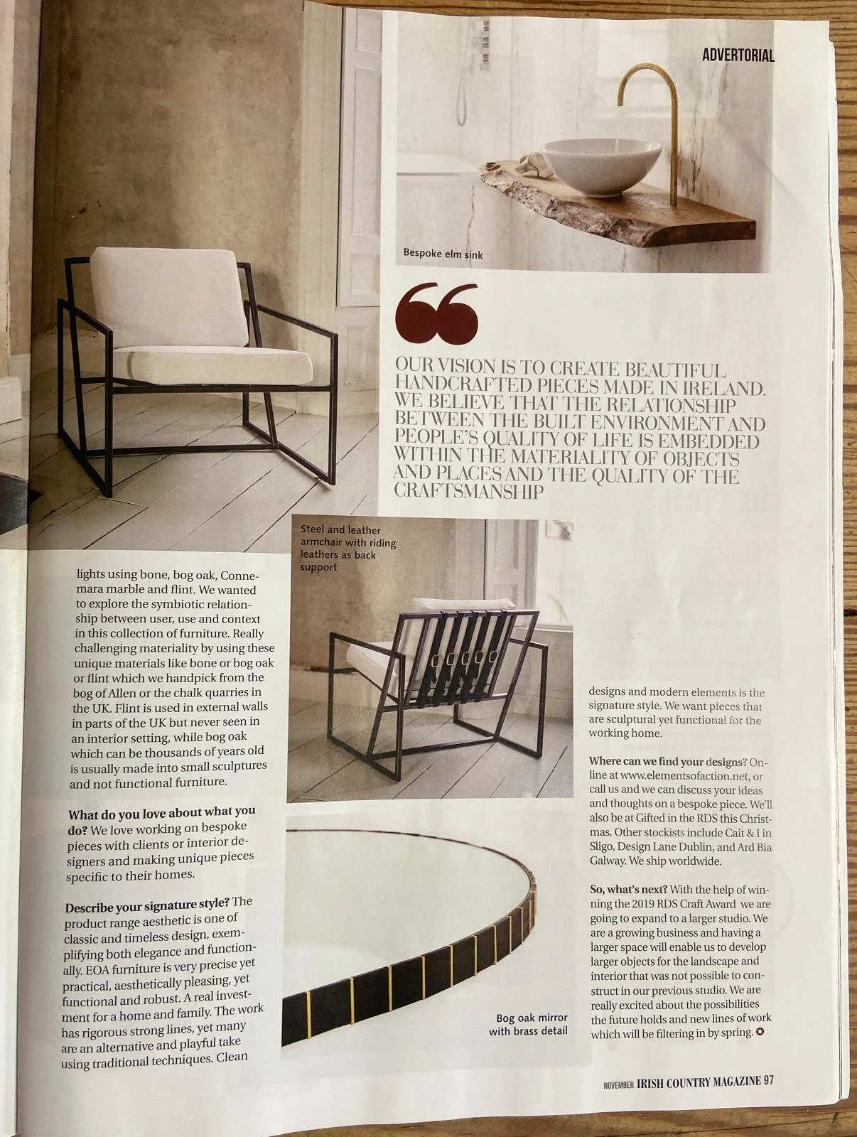 Page from Irish Country Magazine featuring images and descriptions of handcrafted furniture, including a black metal armchair with a white cushion, a bespoke elm sink with a wooden countertop and gold faucet, and a black steel and leather armchair wi