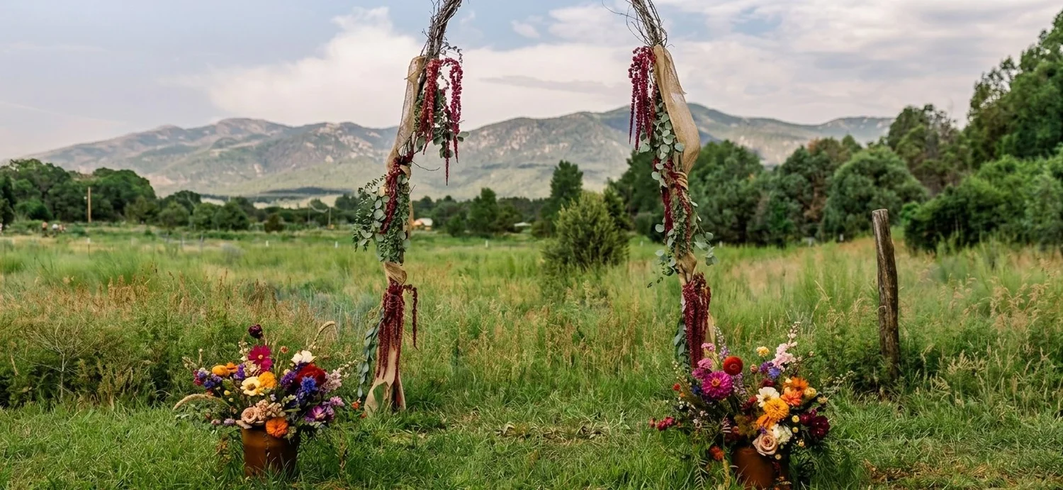 Floral wedding arch with mountains at Taos Goji