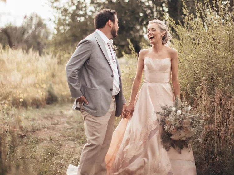 Wedding ceremony under a floral arch at Taos Goji