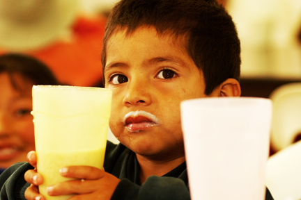 2017_january_baja_outreach_boy+drinking+milk.webp