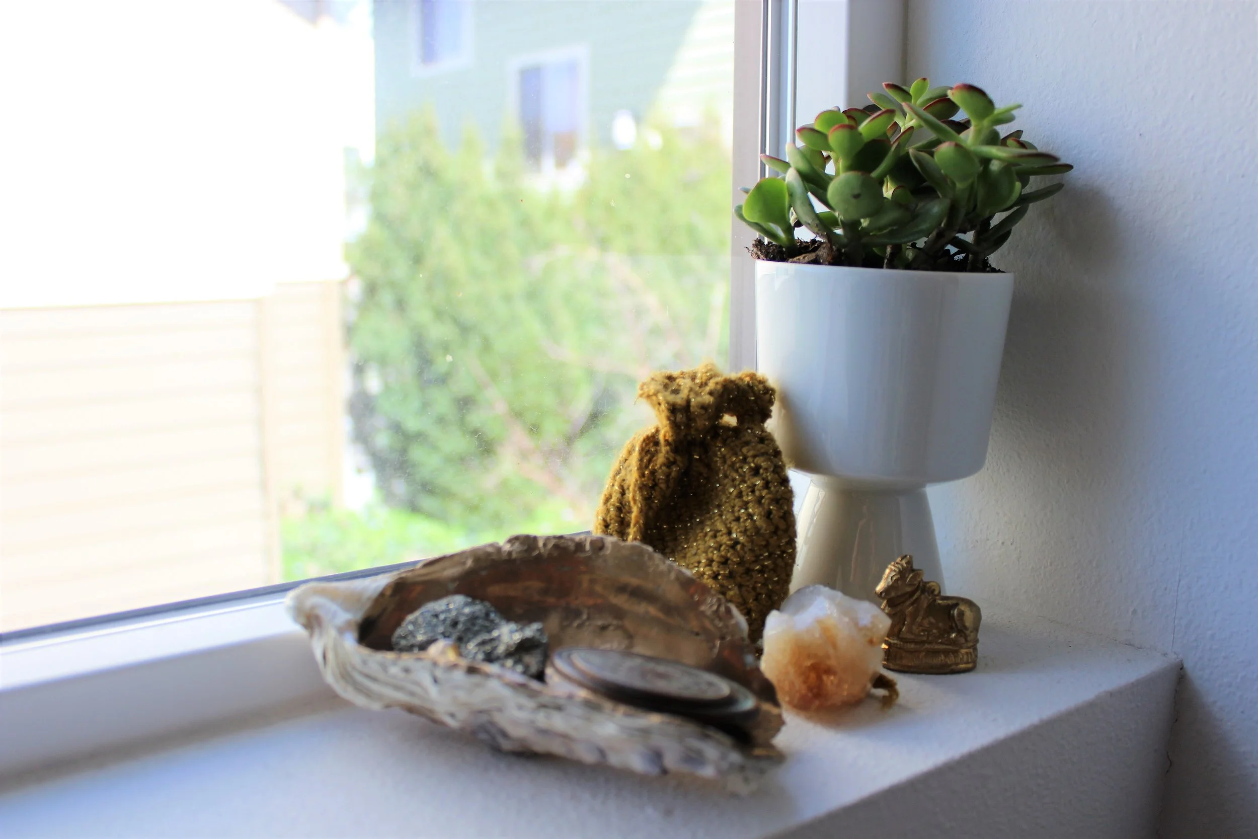 Happy Vesta tip #5: take a more personal approach to feng shui Keep it personal when creating intentional spaces in your home. According to the feng shui bagua map , my wealth, power and abundance area is in the stairway of my three-story home. Instead of viewing this as negative, I like to imagine the stair leading upward, toward wealth and success, and not tumbling down the narrow stairway. I decided to use objects that symbolize abundance to me , while avoiding the more traditional items like a fish tank or dragon figurine, which would feel out of place in my home. I chose a nice, bright window sill in my stairway to place ancient coins, a tiny gold cow (a symbol of wealth) from India, citrine, pyrite, a jade plant and a lucky charms money bag from one of my favorite spiritual teachers, Samantha Fey .