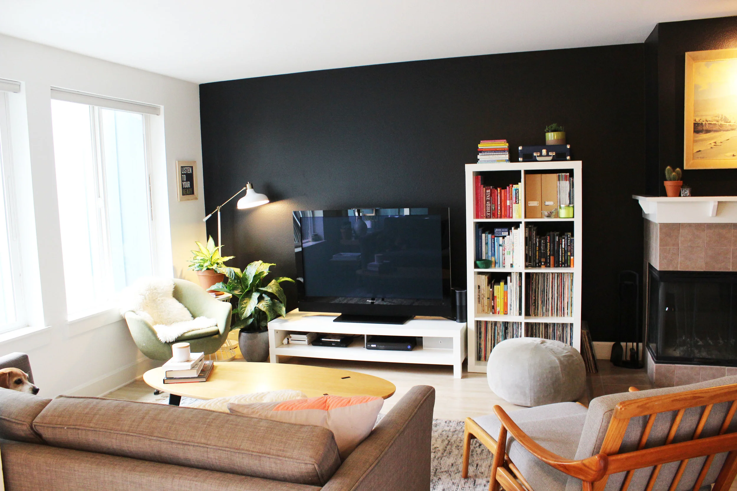 AFTER: Moving the location of the bookcase softens the corner of the room. Switching out a floor lamp and adding a couple plants and artwork creates a warmer, friendlier space. 