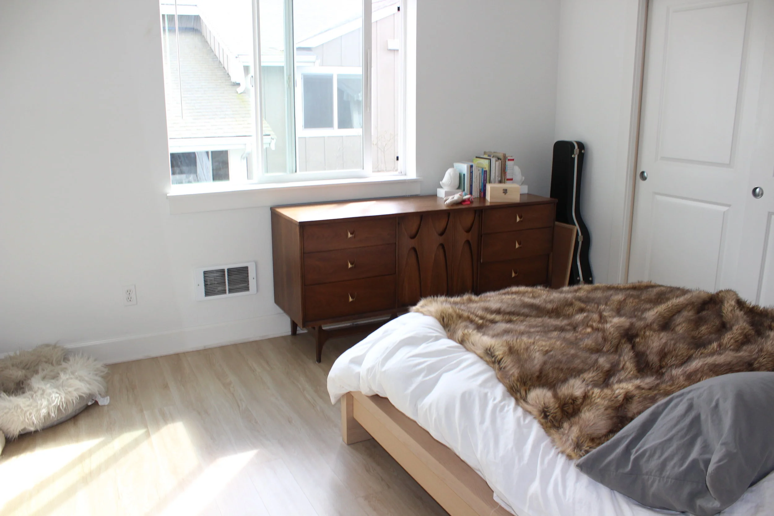 BEFORE: This beautiful mid century dresser feels out of place as it sits partially under the window. 