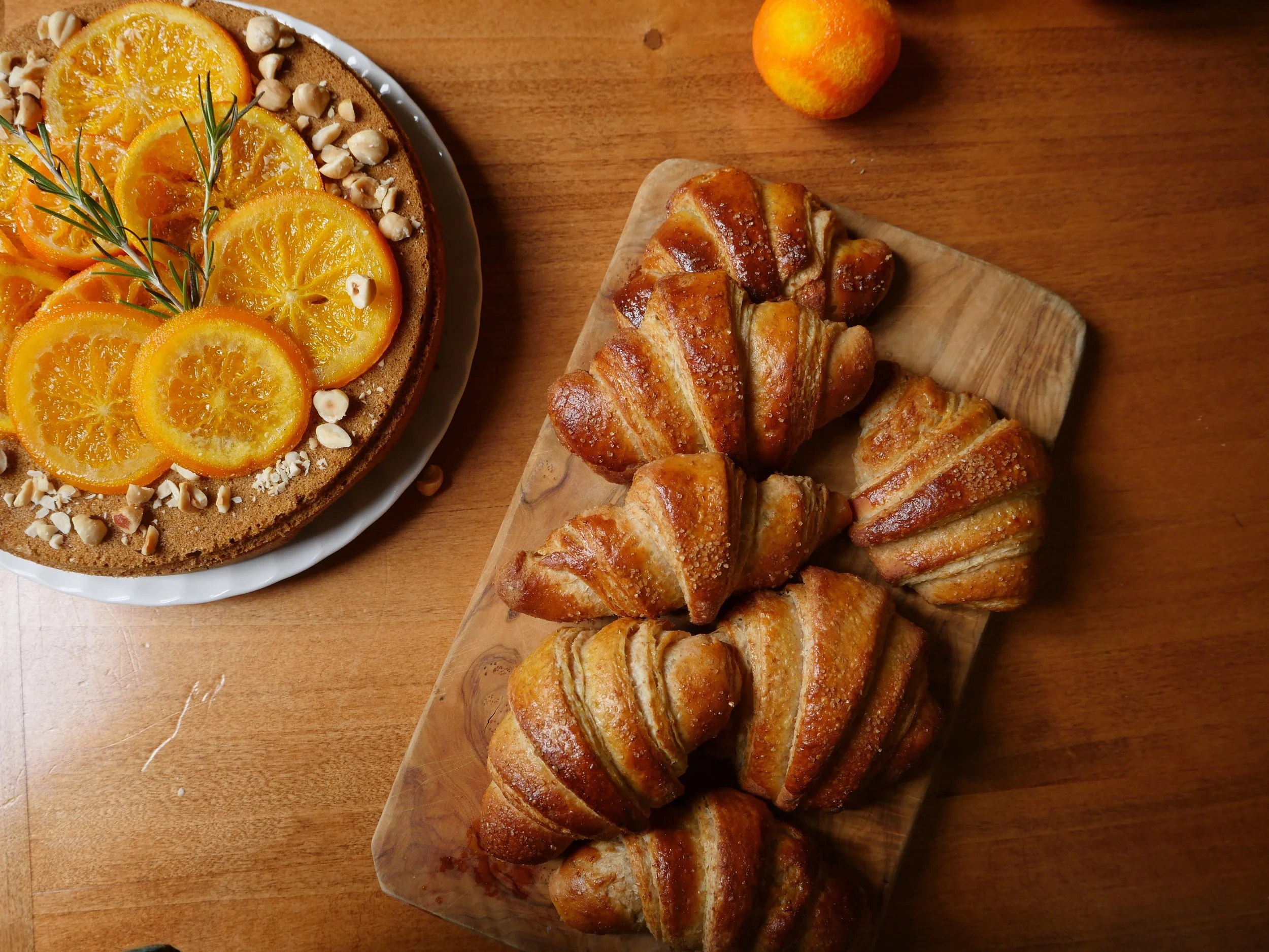 Handmade croissants with spelt flour, orange and hazelnut cake. Anghiari, Italy. 